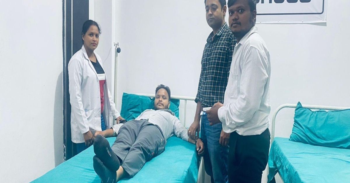 Person with alcohol and drugs on a table