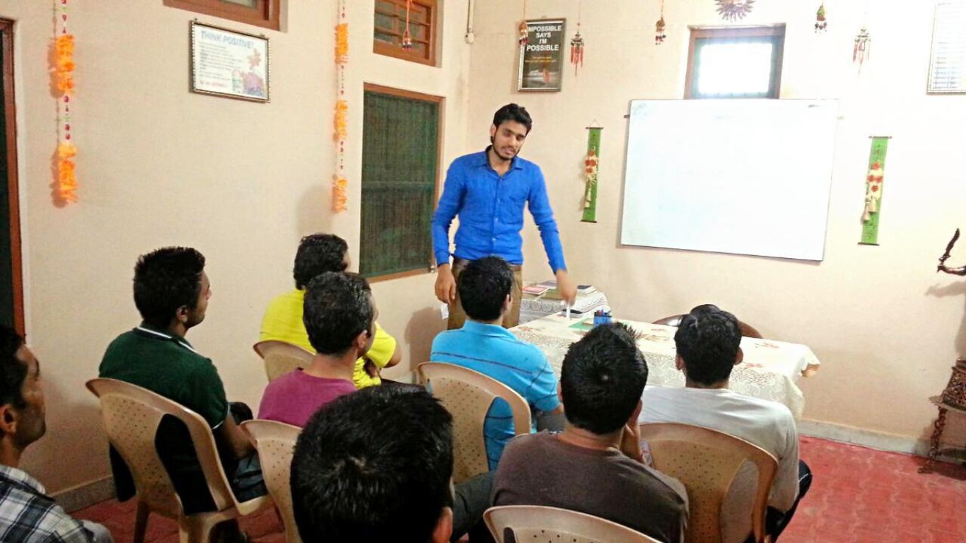 Person with alcohol and drugs on a table